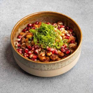 Rustic bean salad topped with pomegranate and herbs