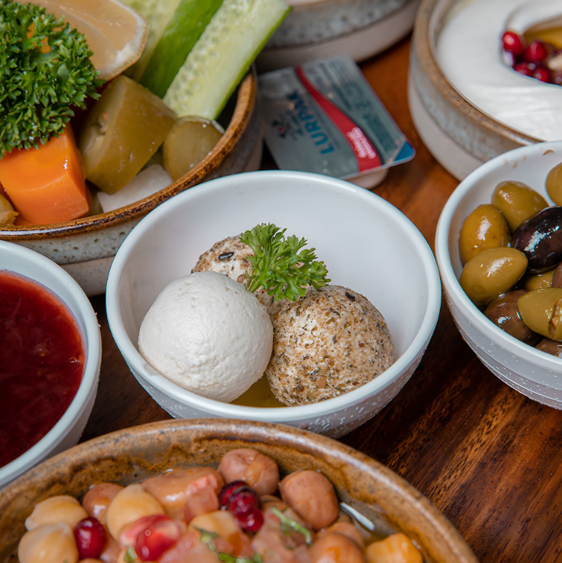 Bowls of Lebanese mezze with olives and creamy dips
