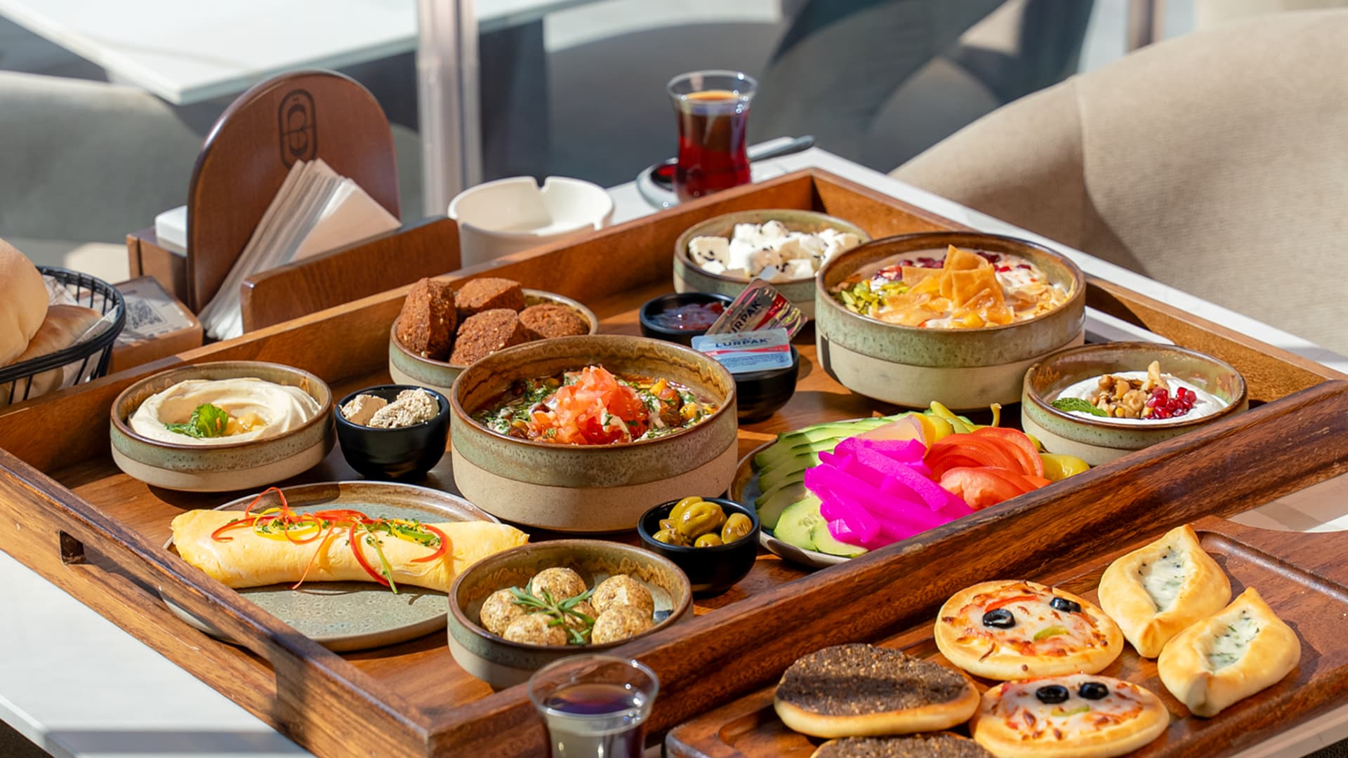 Traditional Middle Eastern breakfast spread and authentic Lebanese food served on a wooden tray at Babati in Business Bay.