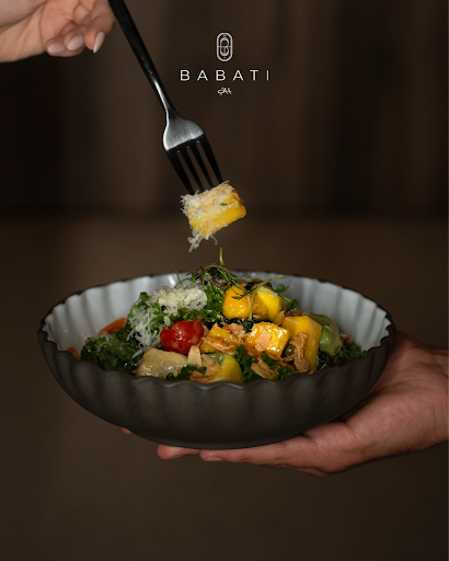Guest enjoying a healthy salad in Babati's for private dining in Dubai